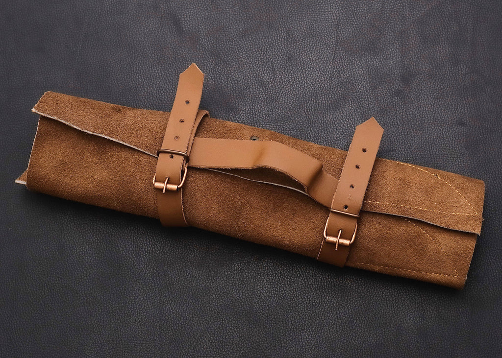 Damascus chef knife set displayed with stitched leather carry roll