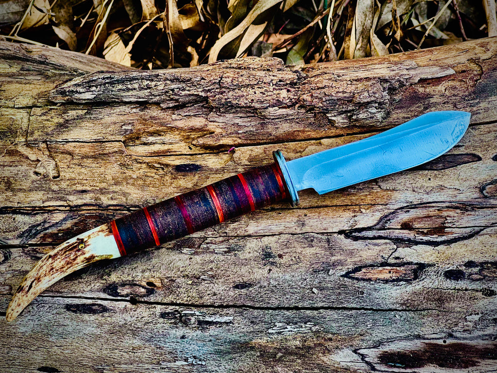 Forged hunting knife with stag antler pommel and cord-wrapped grip