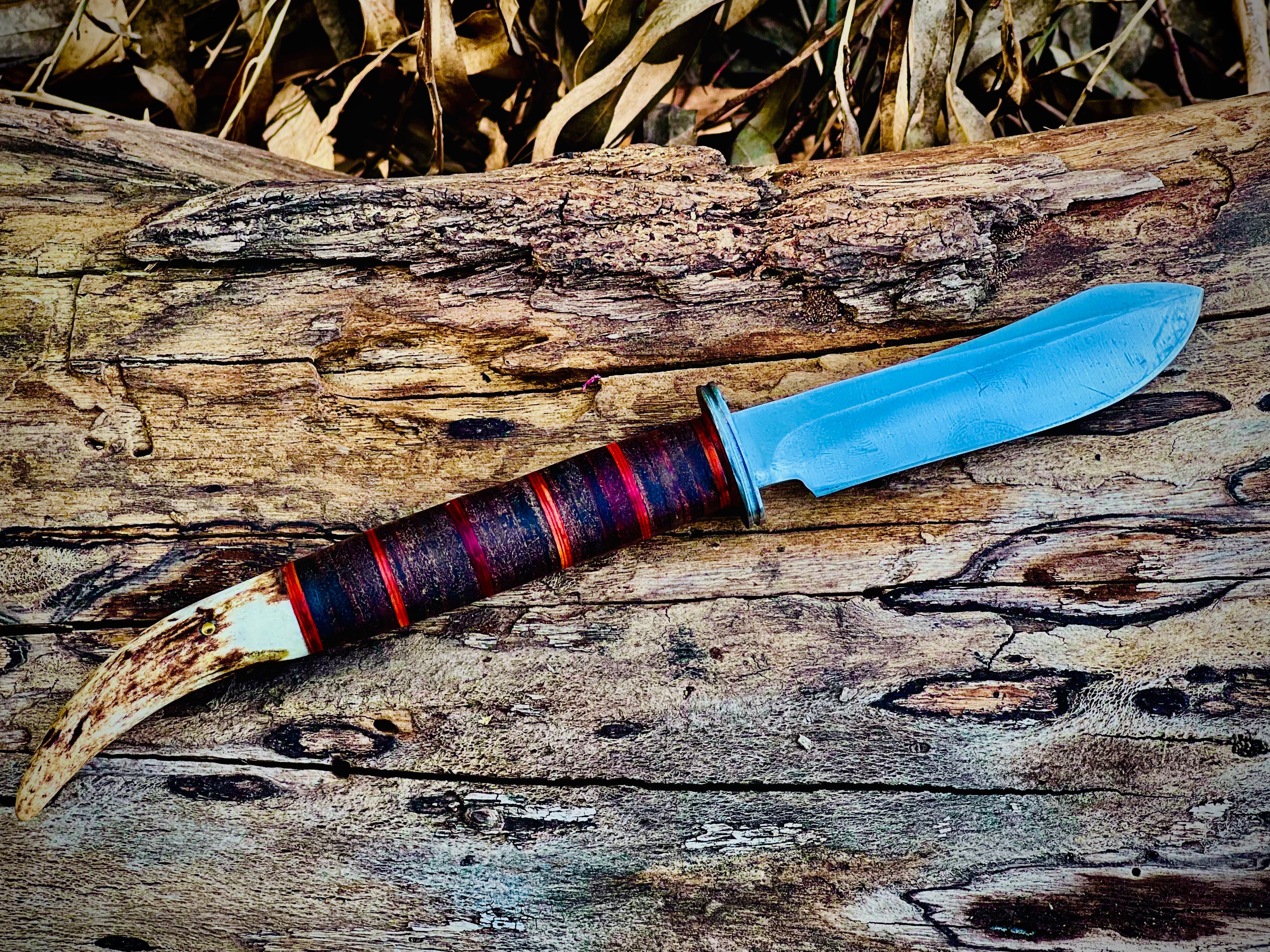 Forged hunting knife with stag antler pommel and cord-wrapped grip
