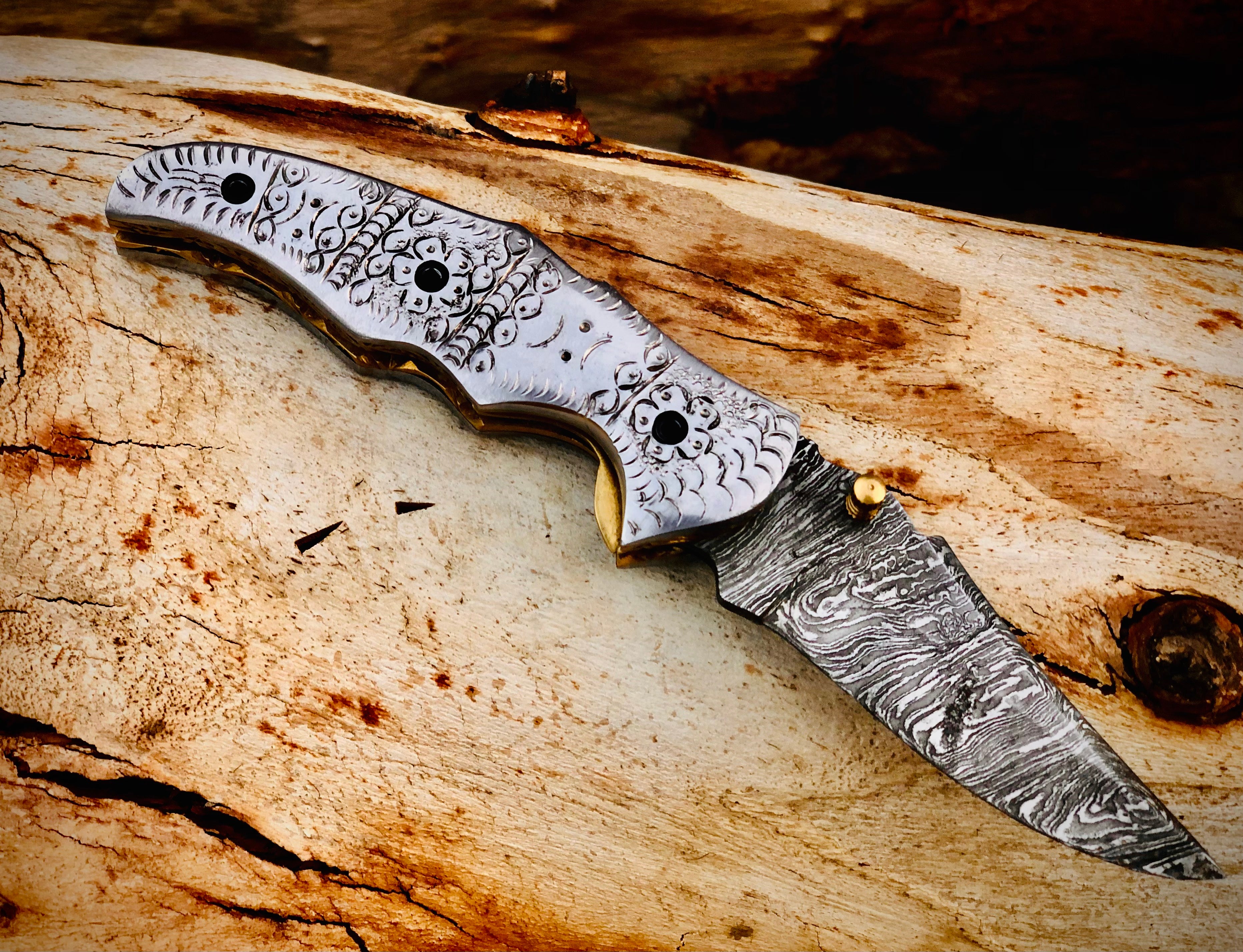 Duskrunner Damascus folding knife with engraved scroll bolsters