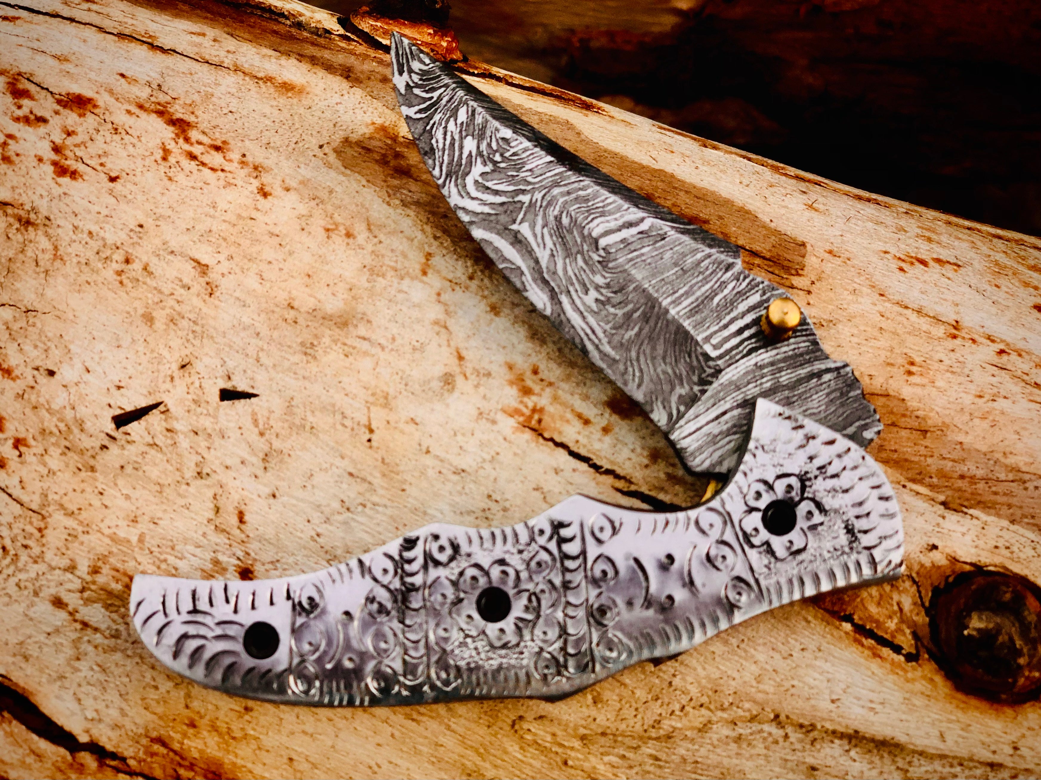 Duskrunner Damascus folding knife with engraved scroll bolsters