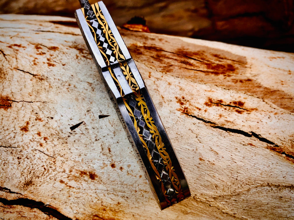 Duskrunner Damascus folding knife with engraved scroll bolsters