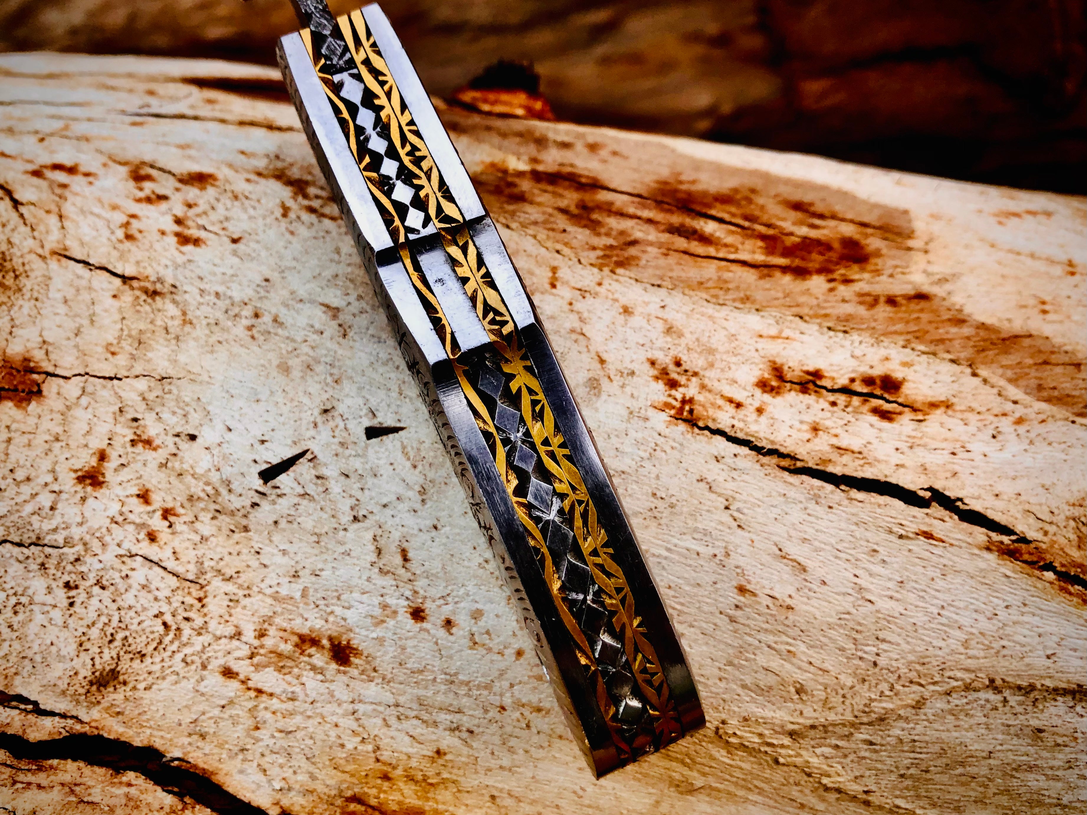 Duskrunner Damascus folding knife with engraved scroll bolsters