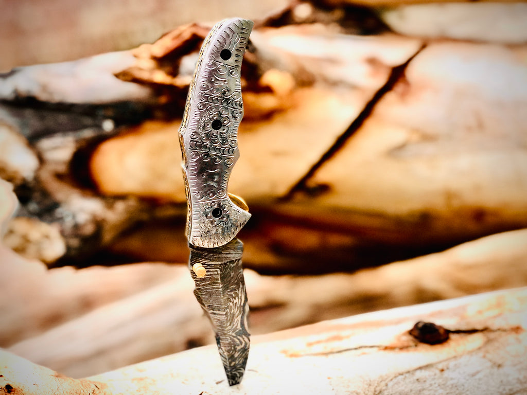 Duskrunner Damascus folding knife with engraved scroll bolsters