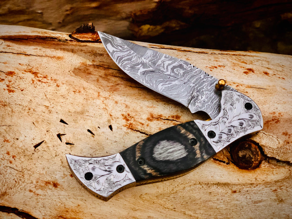 Wolfmoon Damascus folding knife with burl wood handle and engraved bolsters