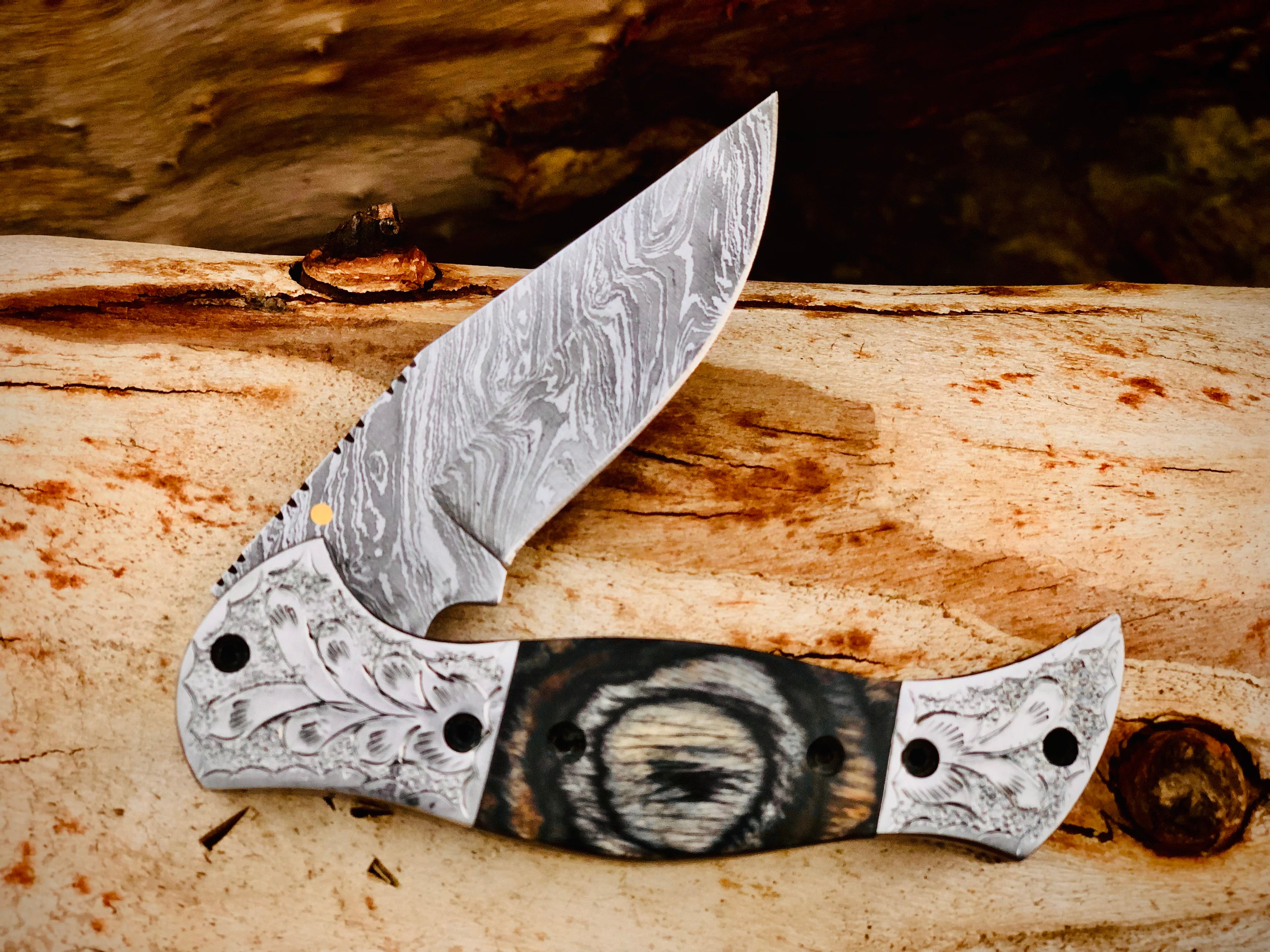 Wolfmoon Damascus folding knife with burl wood handle and engraved bolsters