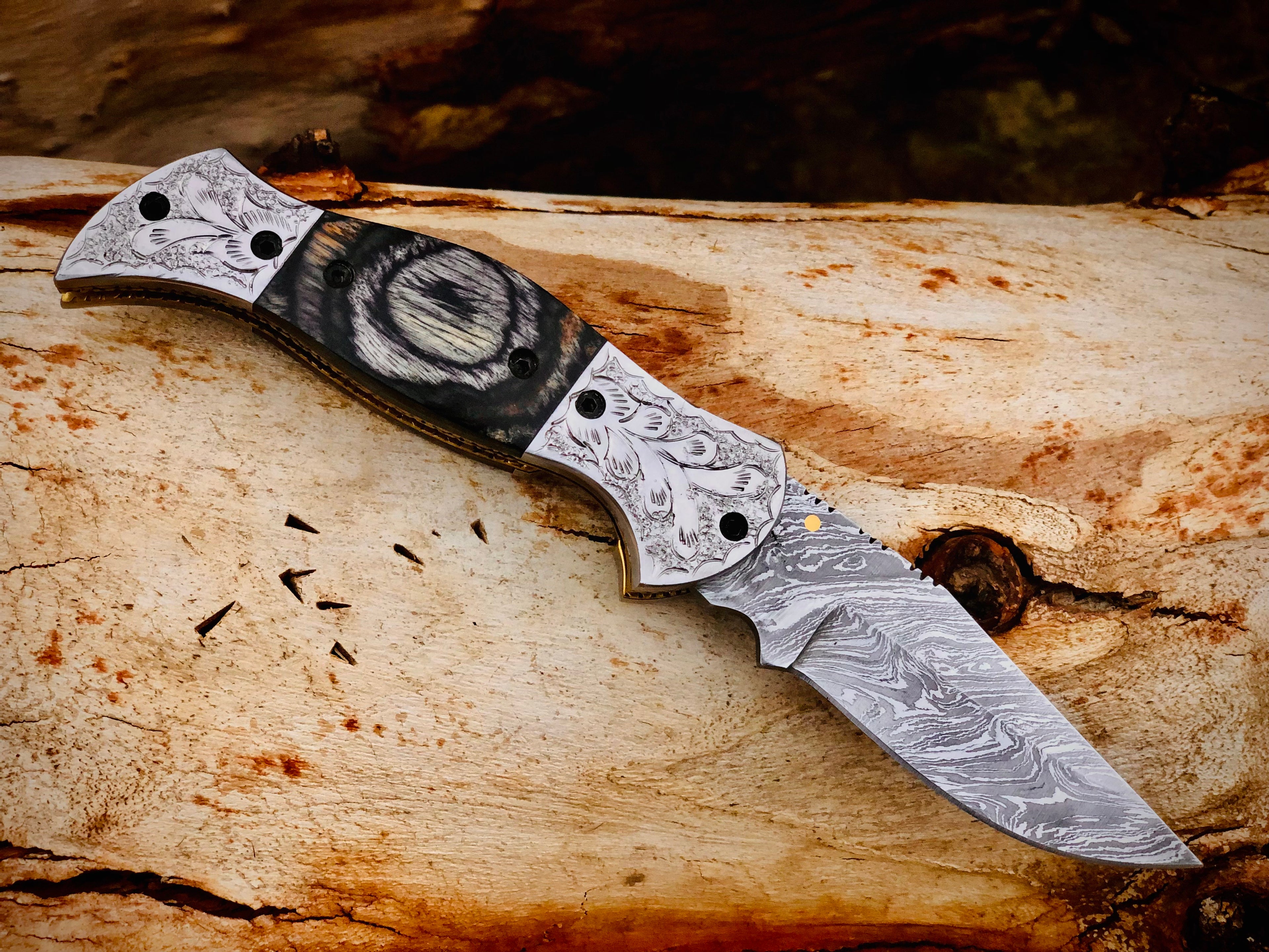 Wolfmoon Damascus folding knife with burl wood handle and engraved bolsters