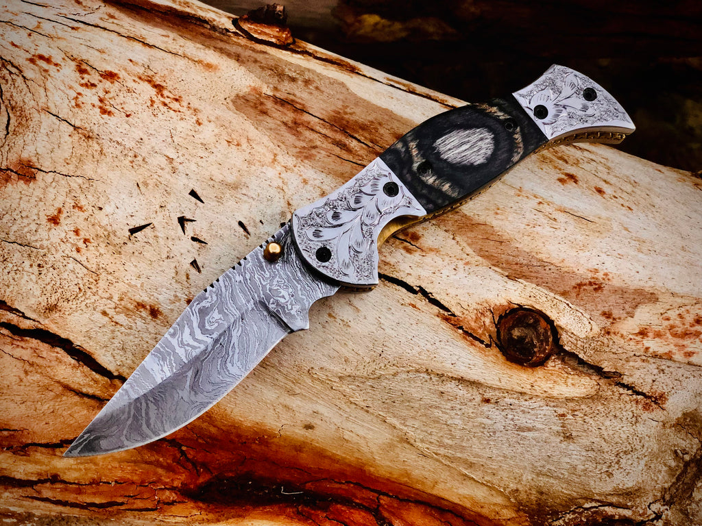 Wolfmoon Damascus folding knife with burl wood handle and engraved bolsters