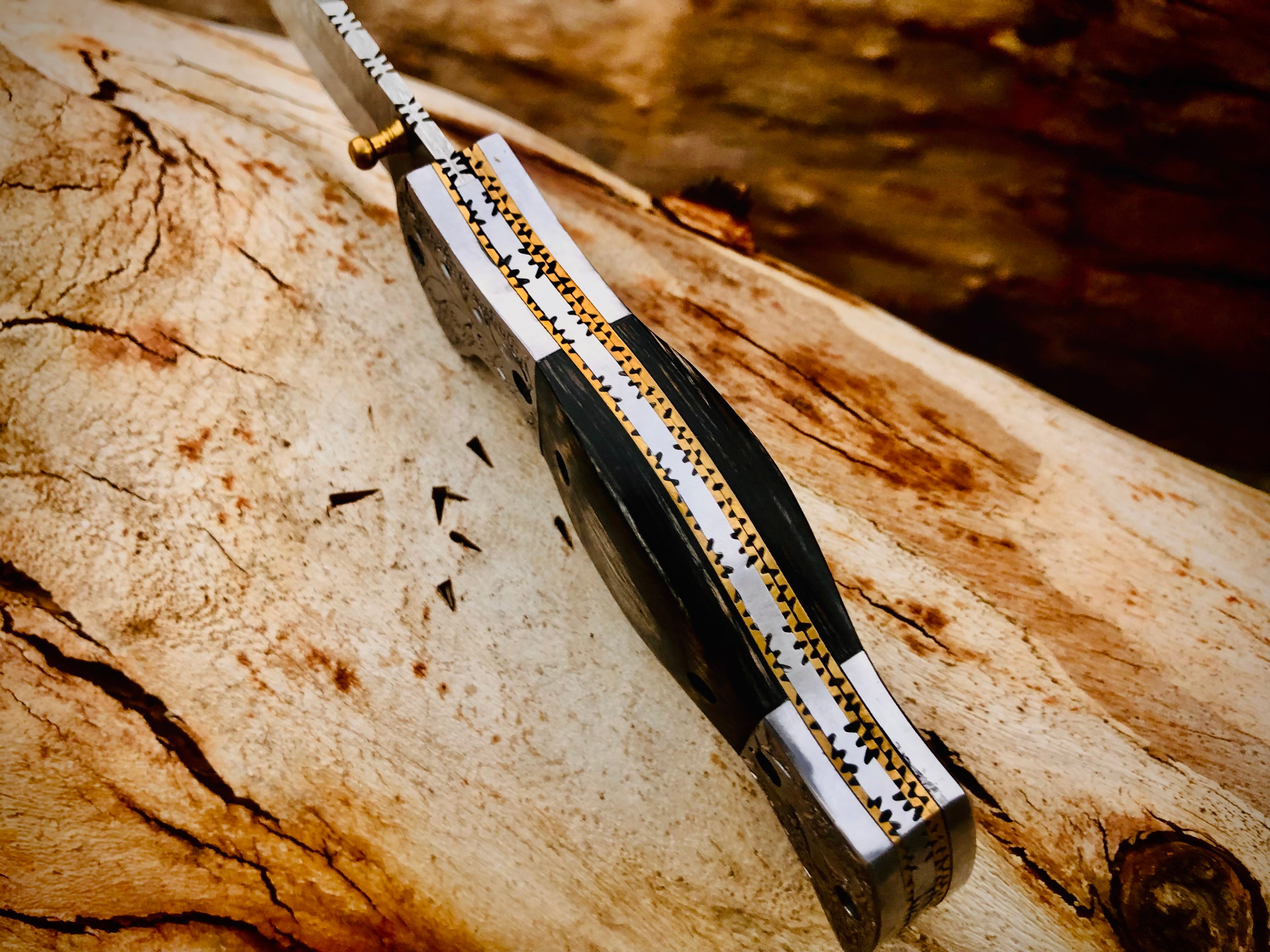 Wolfmoon Damascus folding knife with burl wood handle and engraved bolsters