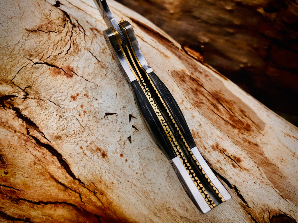 Wolfmoon Damascus folding knife with burl wood handle and engraved bolsters