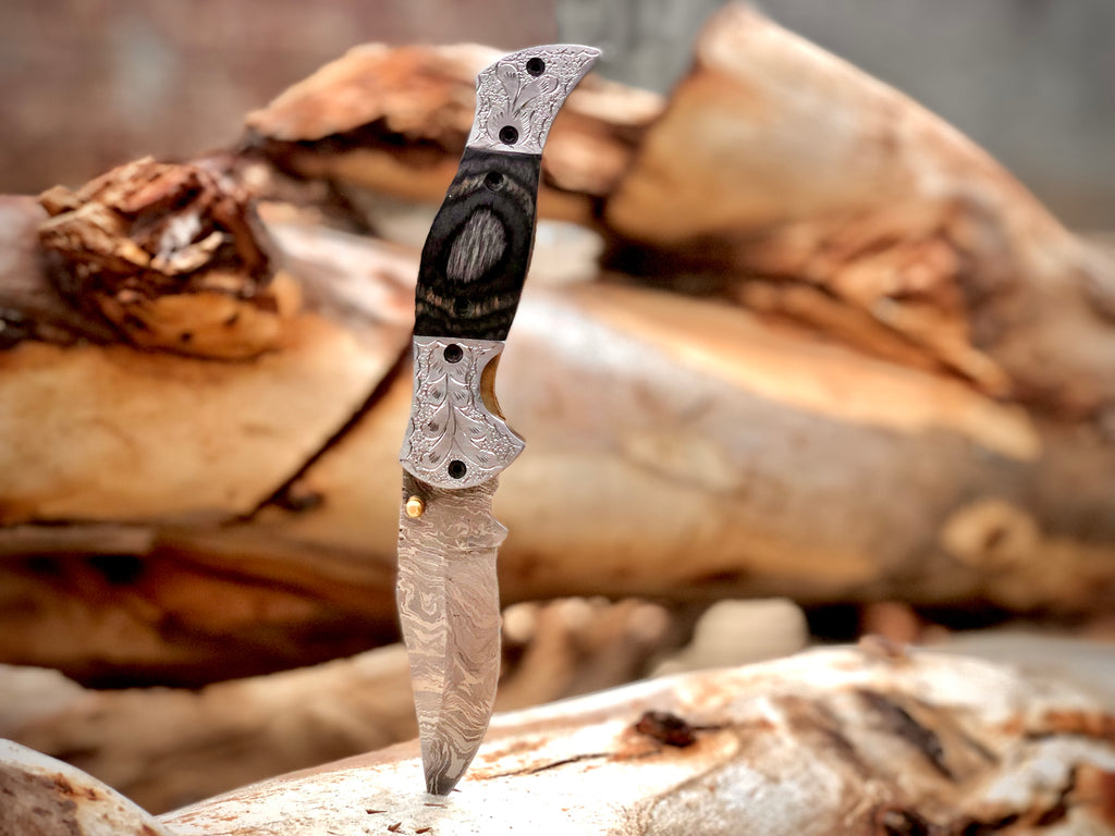 Wolfmoon Damascus folding knife with burl wood handle and engraved bolsters