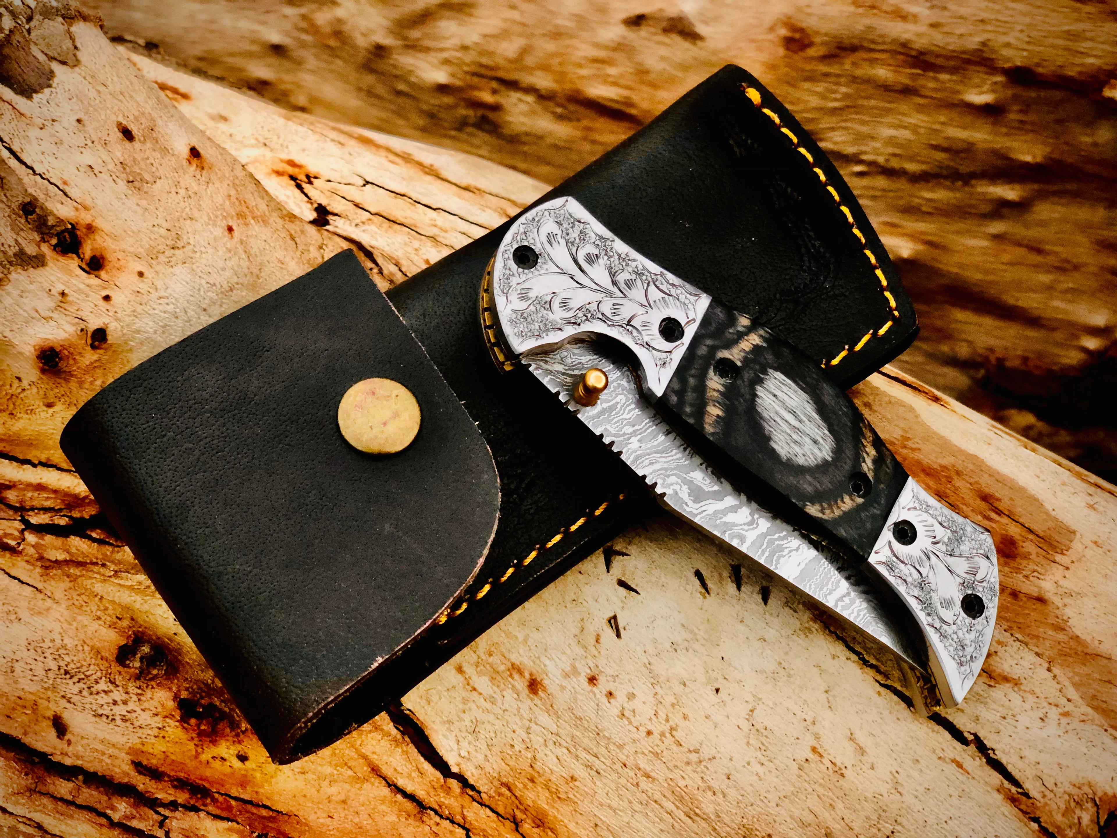 Wolfmoon Damascus folding knife with burl wood handle and engraved bolsters