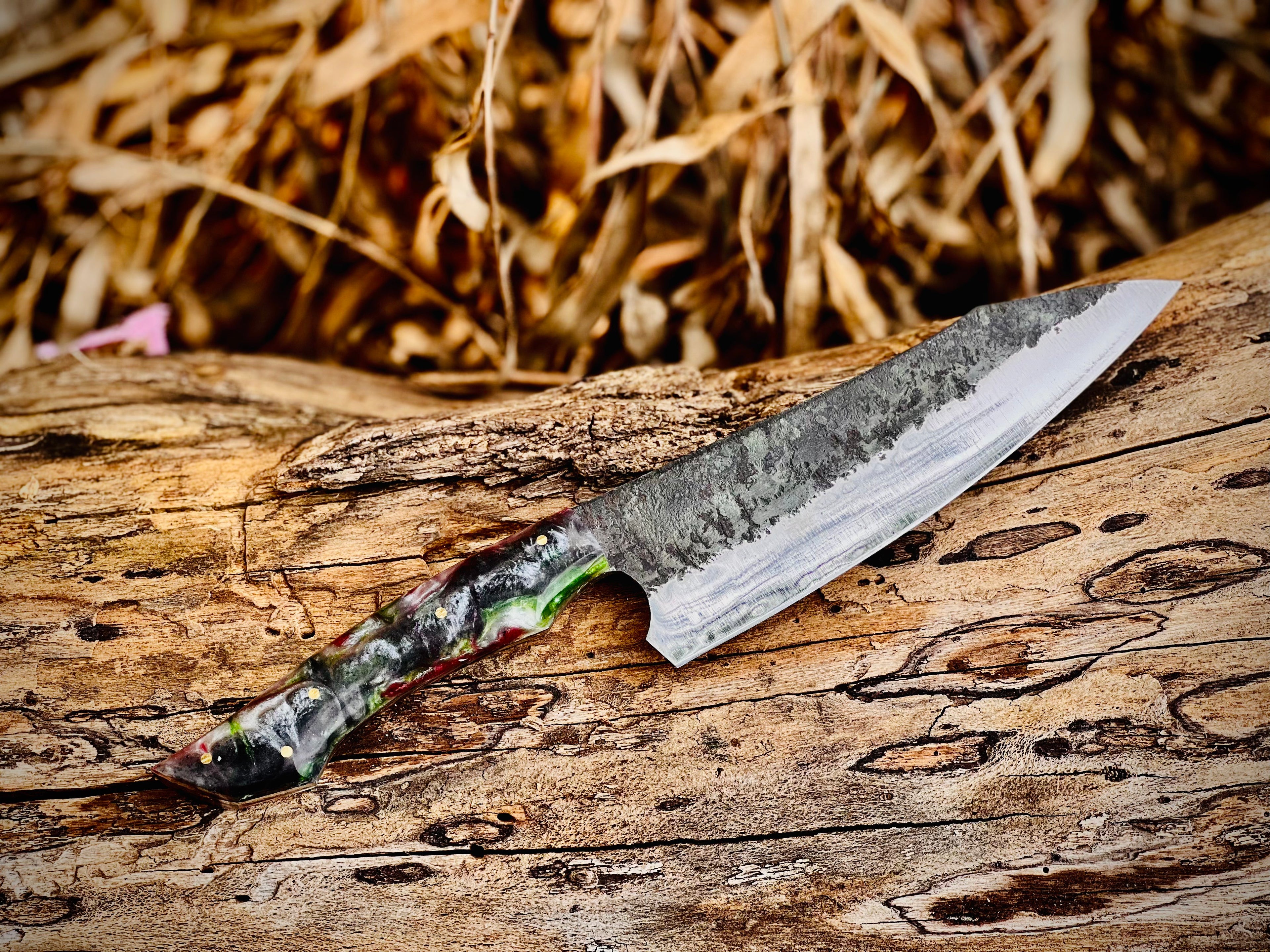 Forged chef knife with red and green resin handle