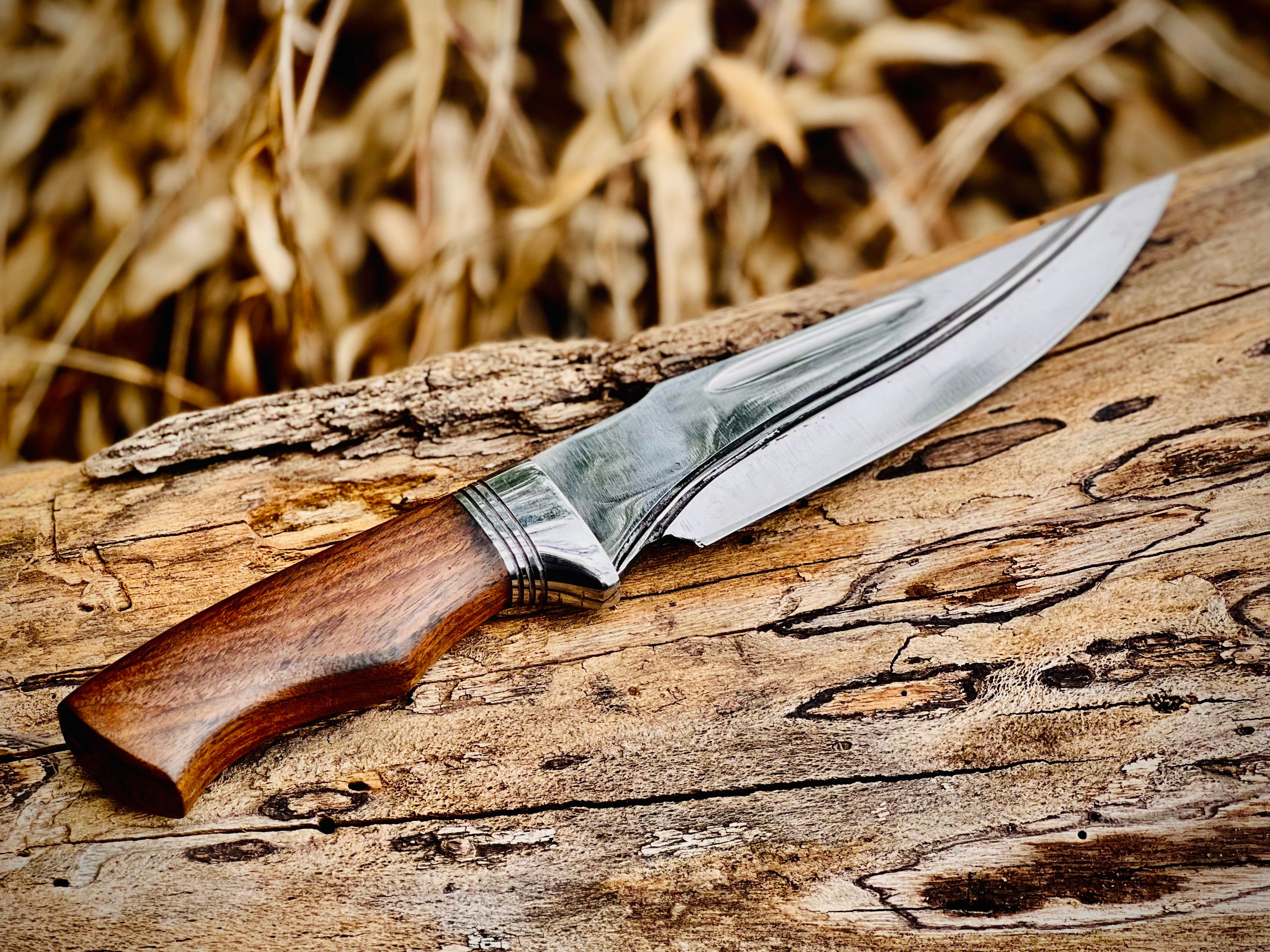 Forged hunting knife with walnut handle and polished fixed blade