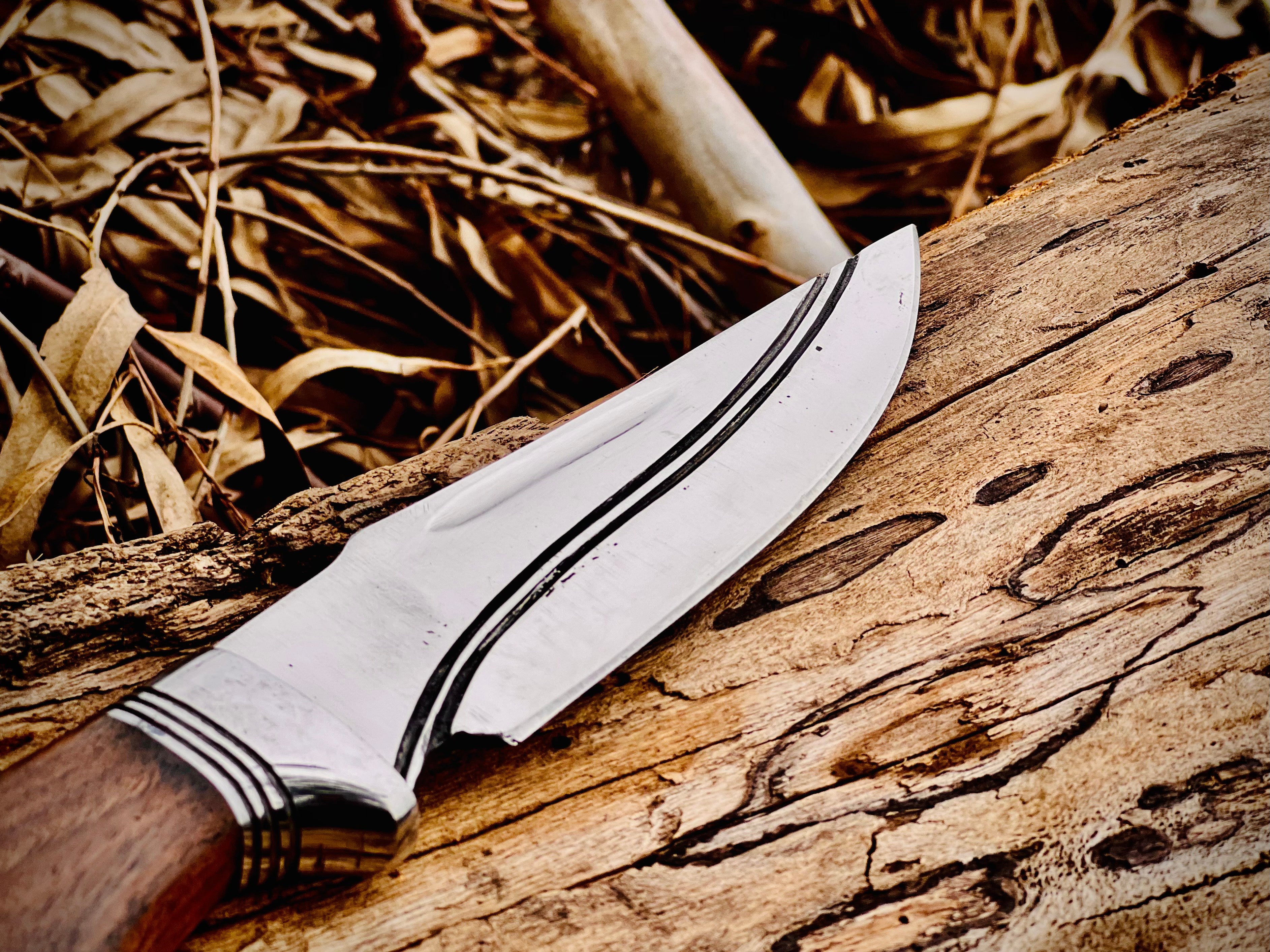 Forged hunting knife with walnut handle and polished fixed blade