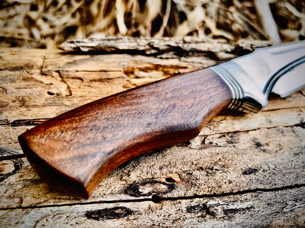 Forged hunting knife with walnut handle and polished fixed blade