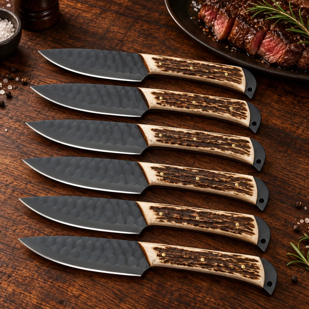 Six stag-handle steak knives with brass pins on a wooden dinner table