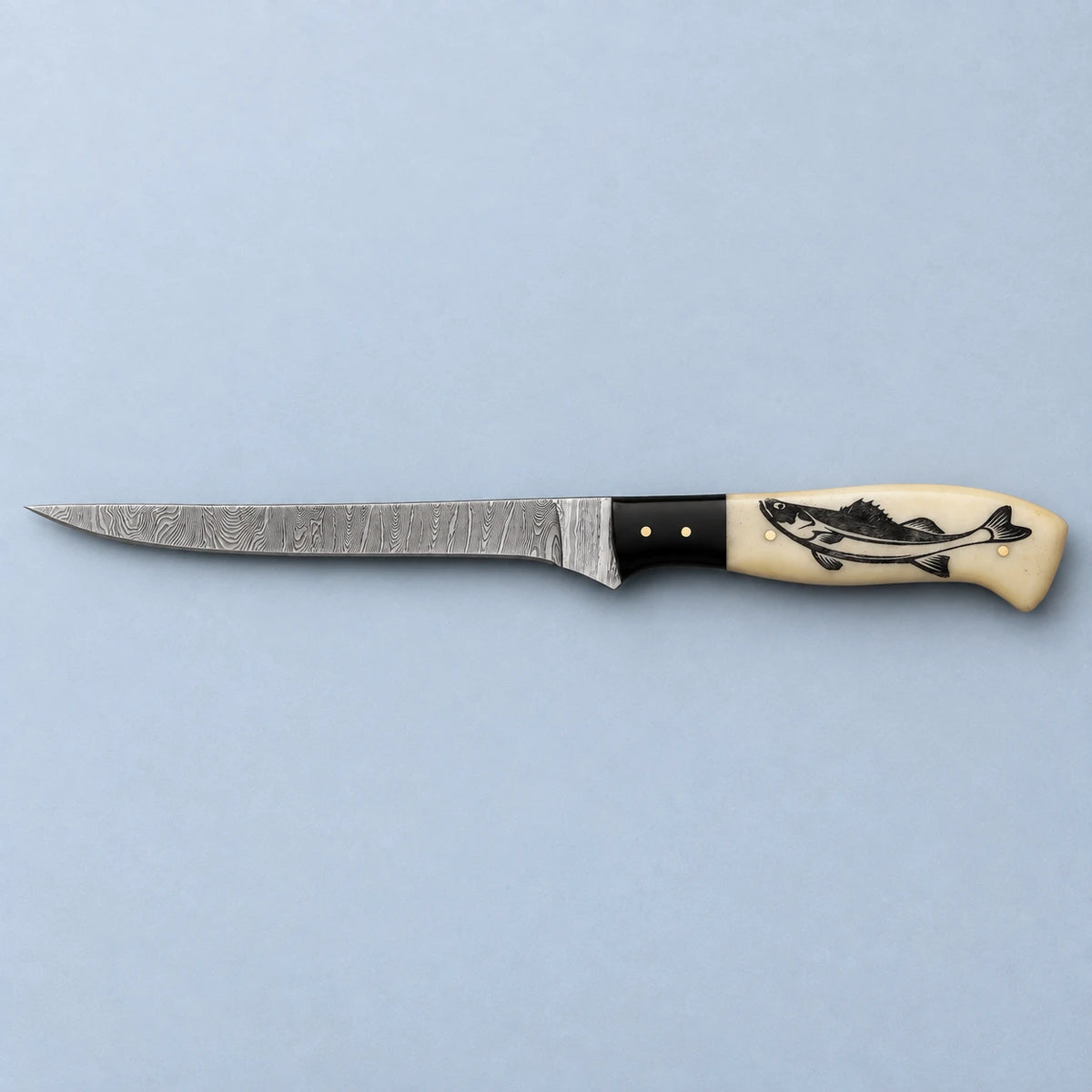 7-inch Damascus fillet knife shown side on, slim blade and engraved fish handle