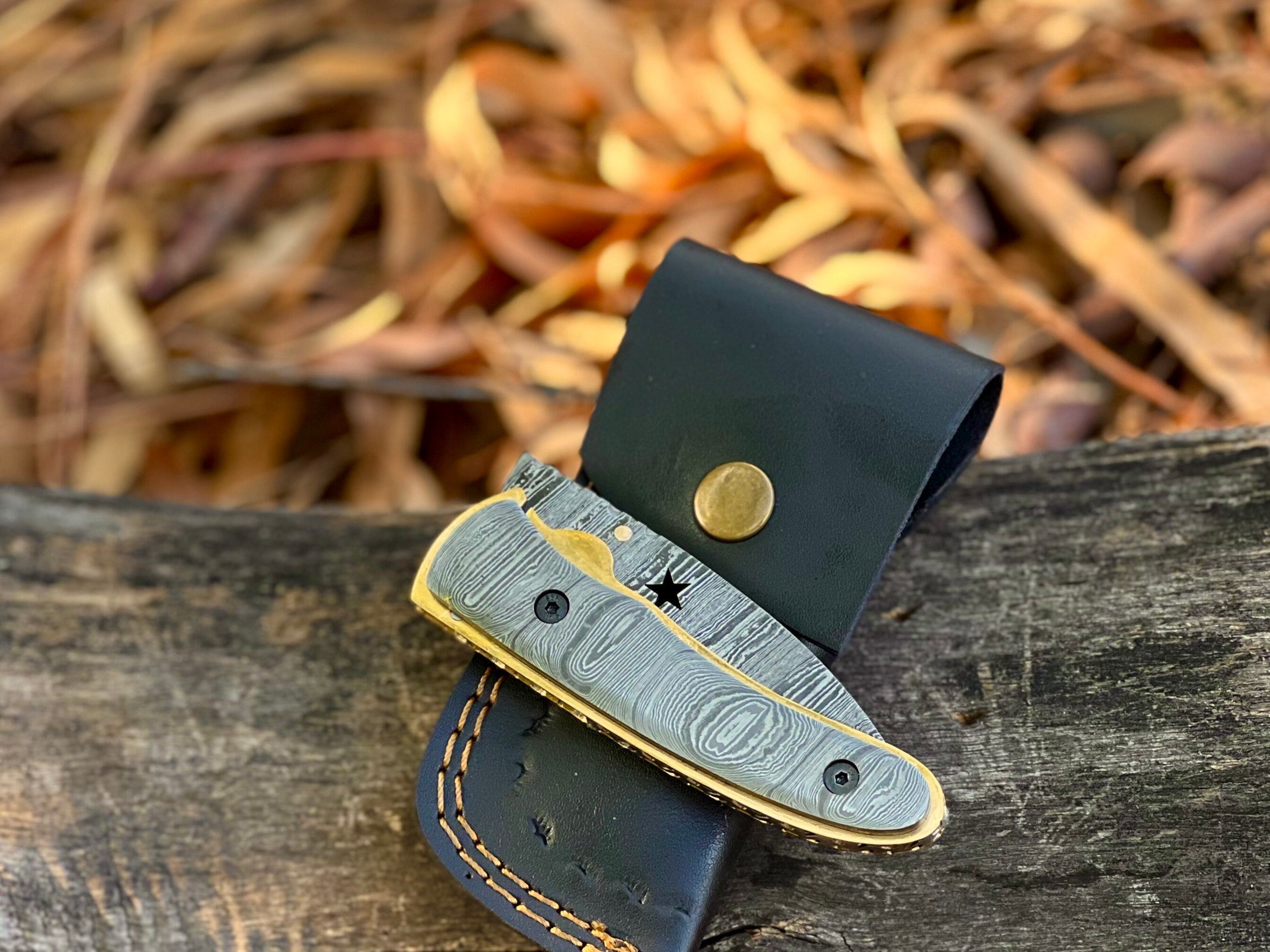 Starforge Damascus folding pocket knife with star-cutout handle