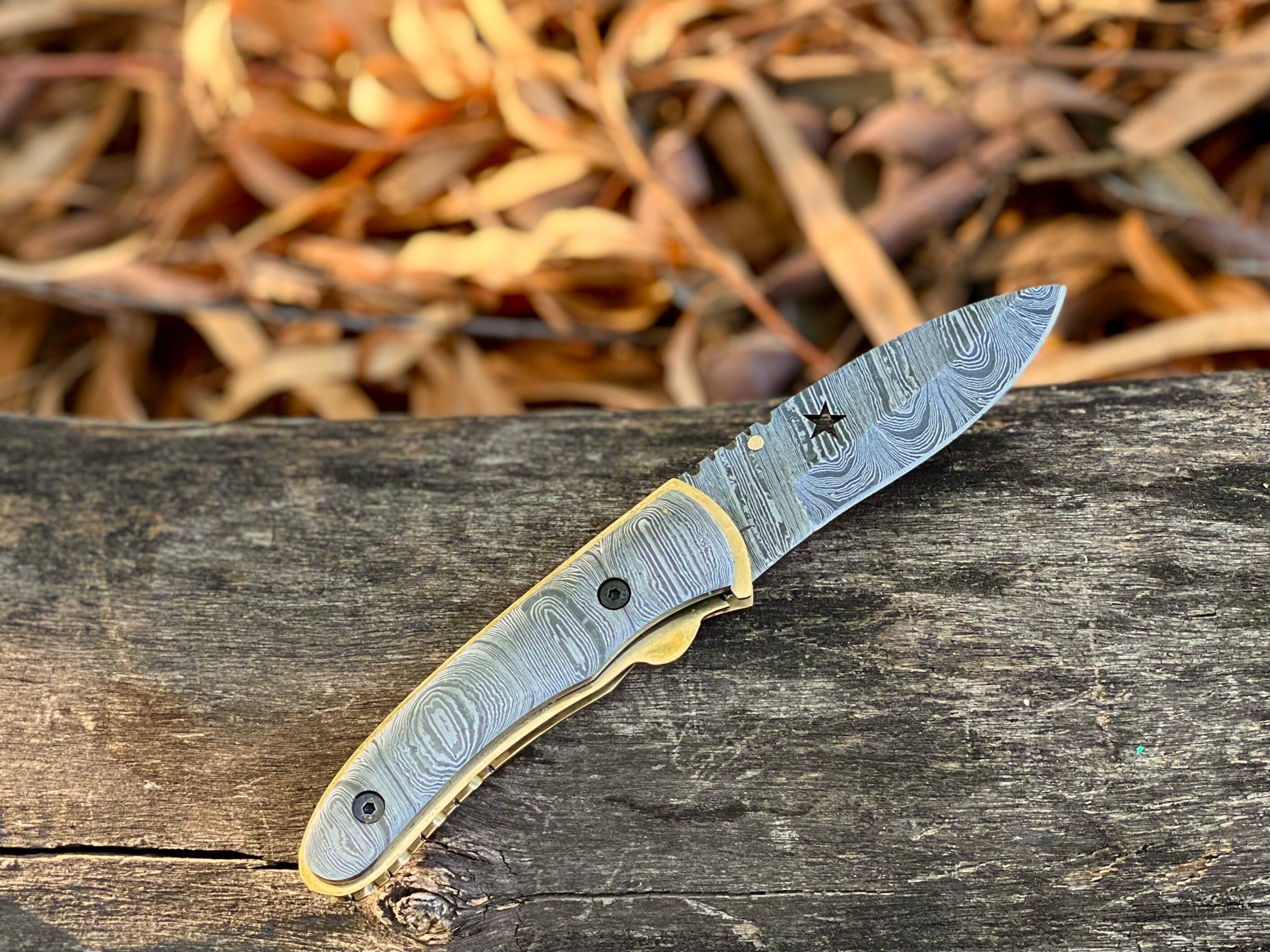 Starforge Damascus folding pocket knife with star-cutout handle