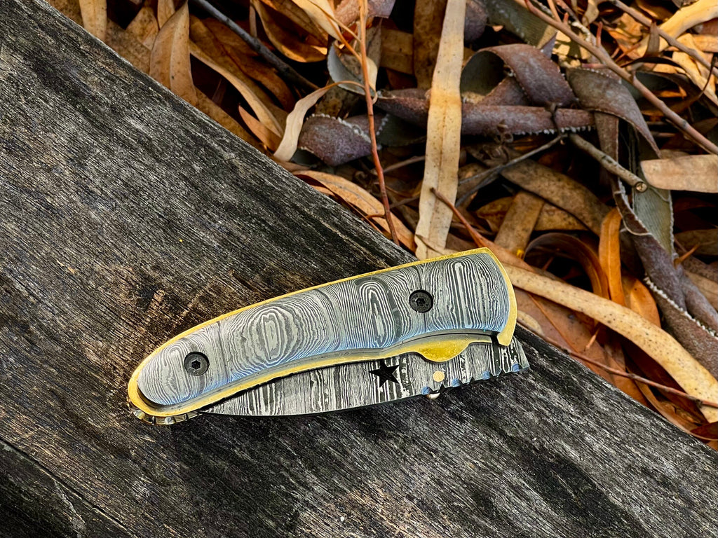 Starforge Damascus folding pocket knife with star-cutout handle