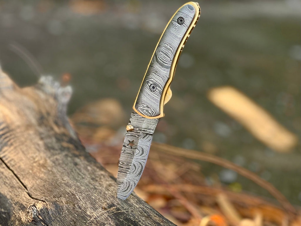 Starforge Damascus folding pocket knife with star-cutout handle