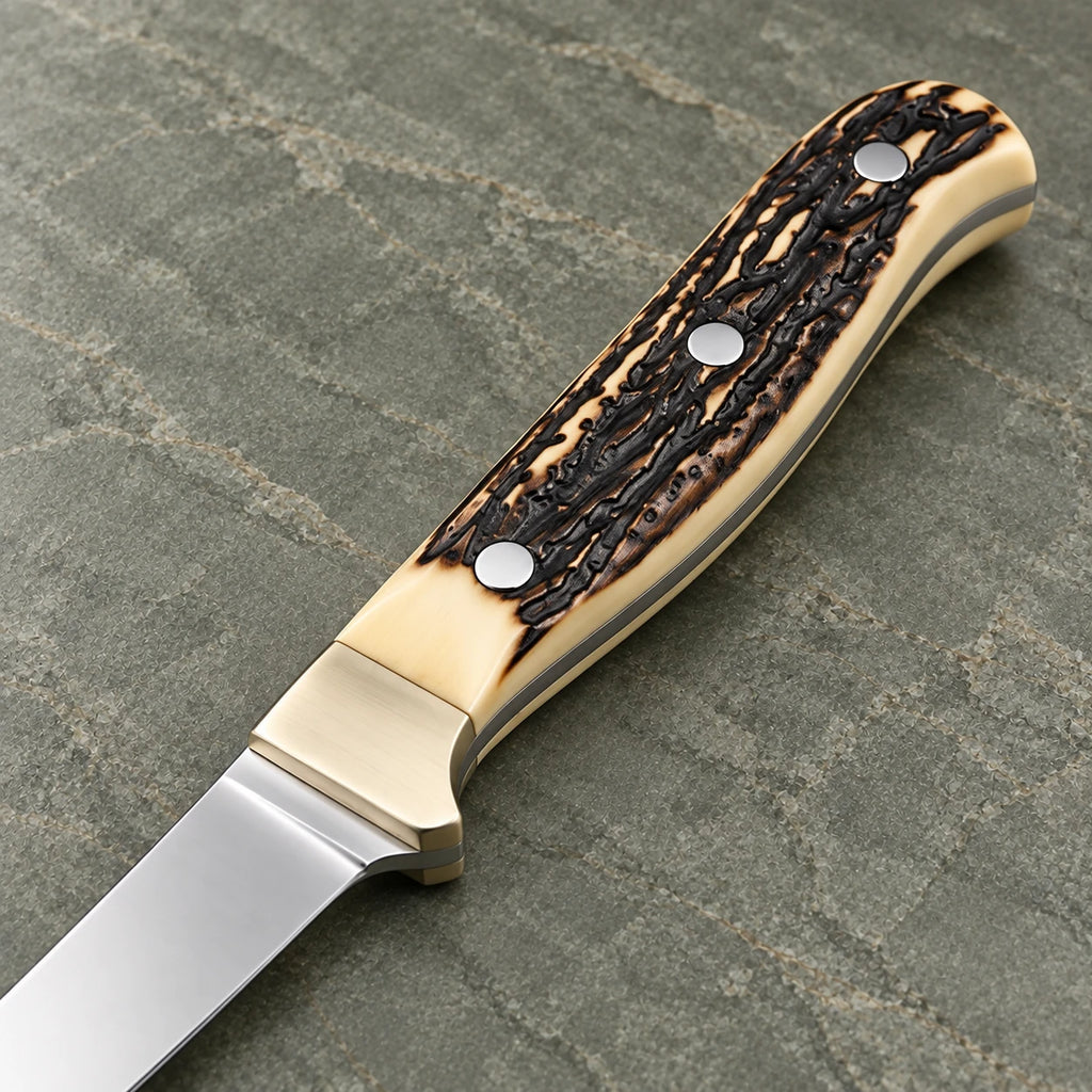 Close-up of the textured stag handle, steel pins and metal bolster