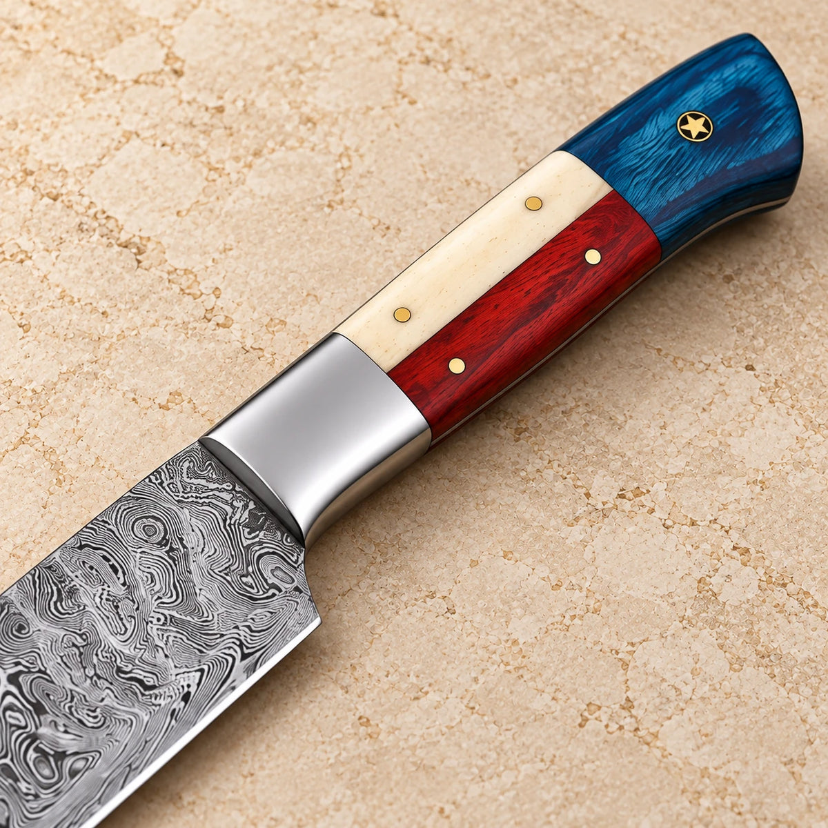 Close-up of the Texas flag handle: blue wood with brass star, camel bone, red wood and stainless bolster